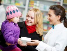 mother with her child assisted by a pharmacist